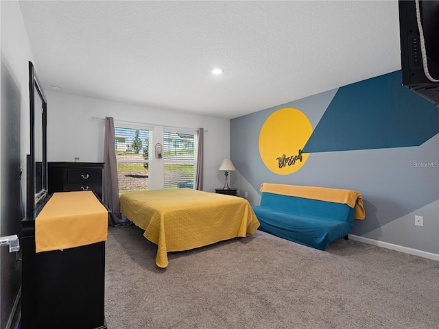 bedroom featuring a textured ceiling and carpet floors