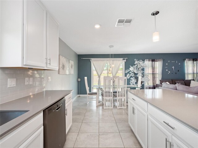 kitchen with white cabinets, tasteful backsplash, hanging light fixtures, light tile patterned floors, and dishwasher