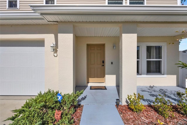 view of exterior entry with a garage