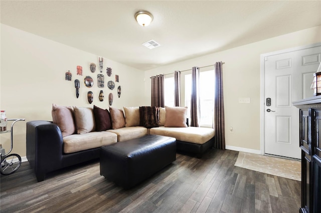 living room featuring a fireplace and dark hardwood / wood-style floors