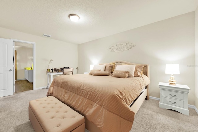 carpeted bedroom with a textured ceiling