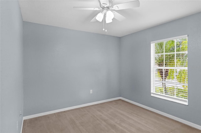 spare room with light carpet, ceiling fan, and plenty of natural light