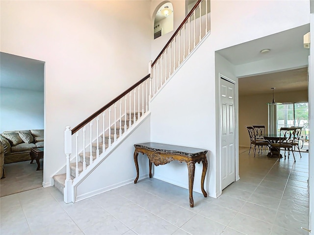 stairway featuring tile patterned flooring