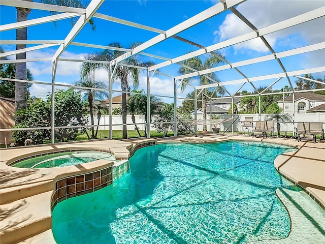 view of swimming pool with a lanai, a patio, and an in ground hot tub