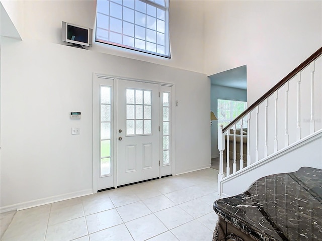 foyer entrance with light tile patterned floors and a wealth of natural light