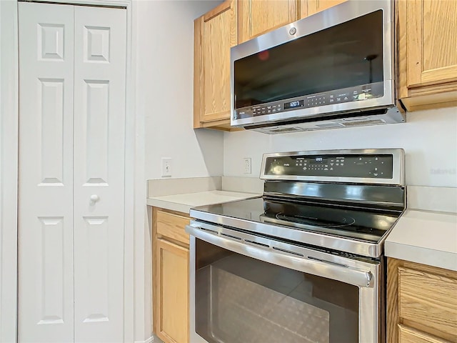 kitchen with appliances with stainless steel finishes and light brown cabinets