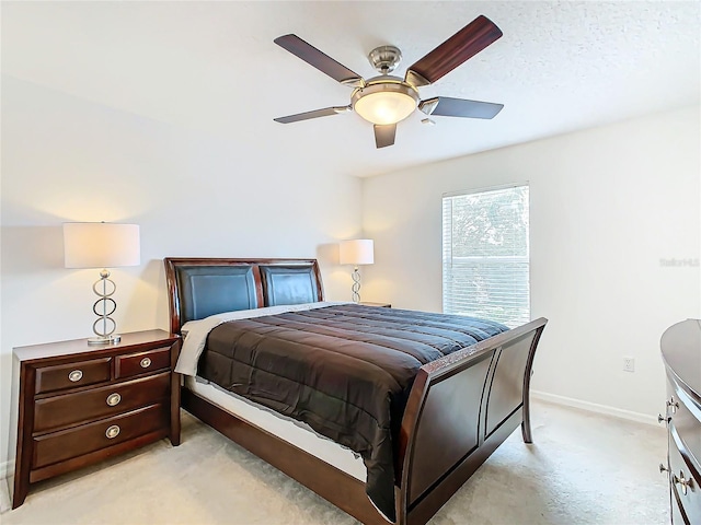 bedroom with light colored carpet and ceiling fan