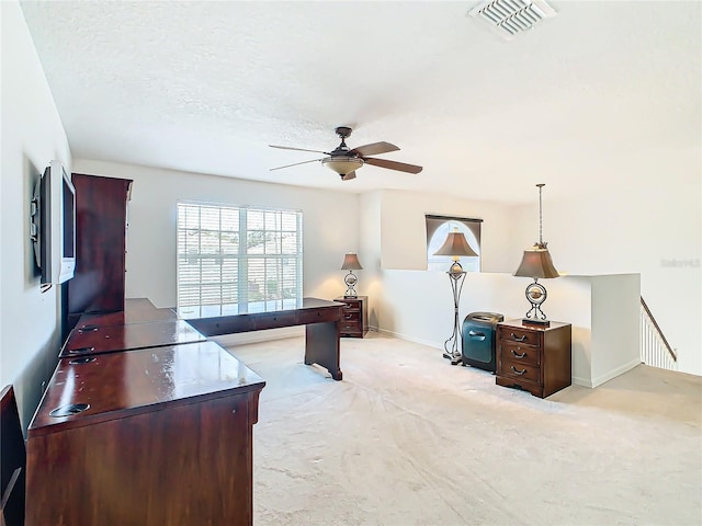 office with light carpet, ceiling fan, and a textured ceiling