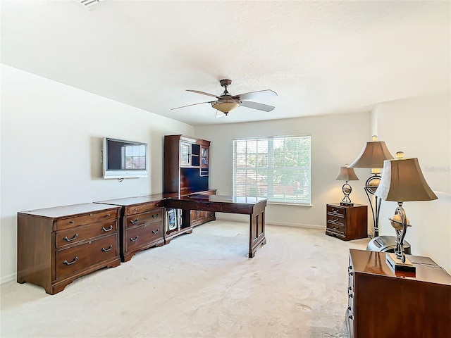 home office featuring light colored carpet and ceiling fan