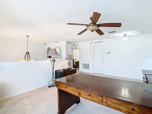 playroom featuring light carpet, ceiling fan, and a textured ceiling