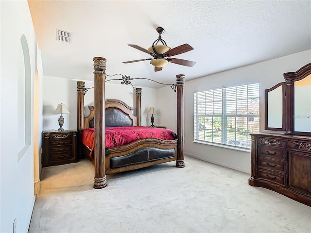 bedroom with ceiling fan and a textured ceiling