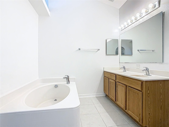 bathroom with tile patterned flooring, vanity, and a tub