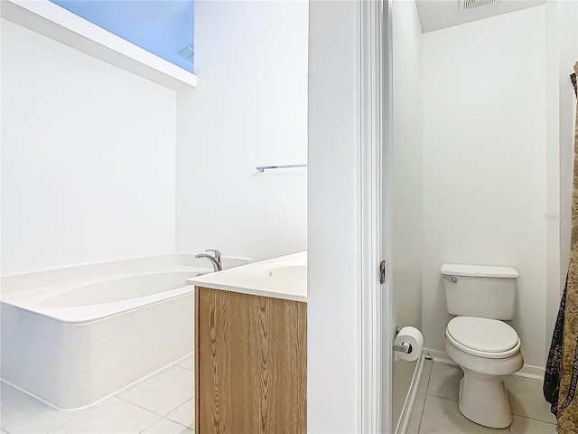 bathroom featuring tile patterned flooring, vanity, a washtub, and toilet