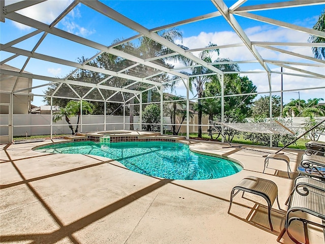 view of pool with an in ground hot tub, a lanai, and a patio