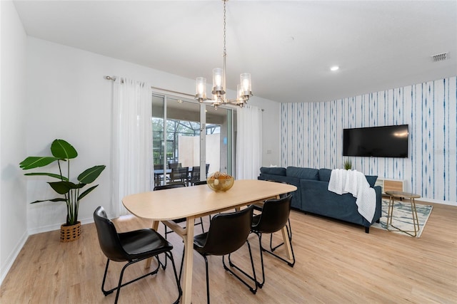 dining area featuring an inviting chandelier and light wood-type flooring