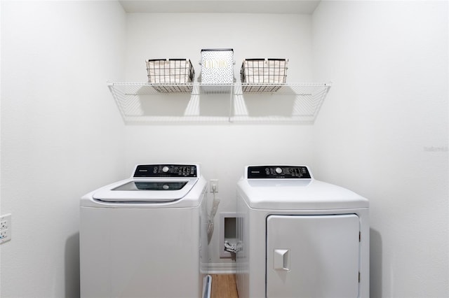 clothes washing area featuring independent washer and dryer