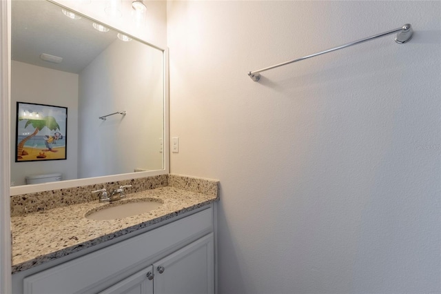 bathroom with toilet and vanity