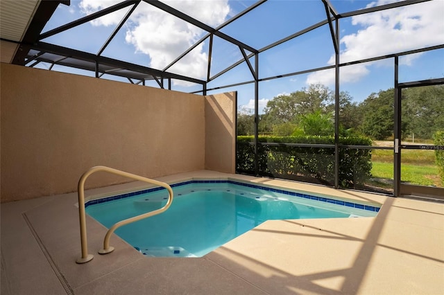 view of pool featuring a patio area and glass enclosure