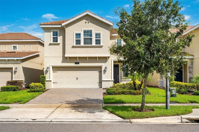 view of front of home with a garage and a front lawn