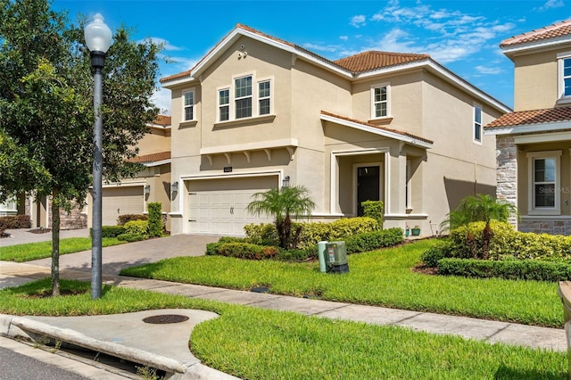 view of front of home featuring a front yard and a garage