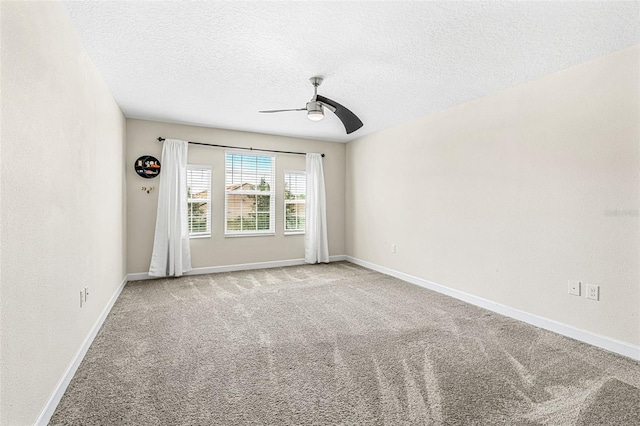 carpeted empty room featuring ceiling fan and a textured ceiling