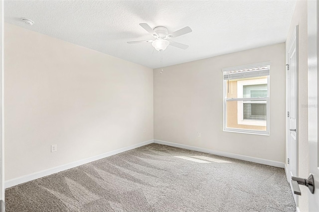 unfurnished room featuring a textured ceiling, carpet flooring, and ceiling fan