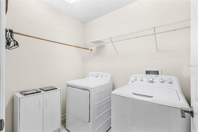 washroom with independent washer and dryer and a textured ceiling