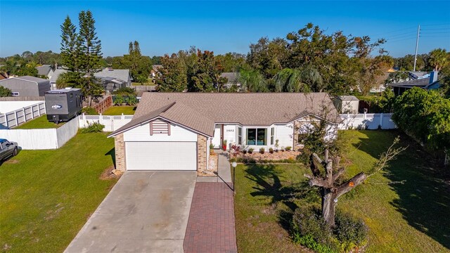 1402 Westminster Way, Kissimmee, FL 34744 - ranch-style home with driveway and a garage