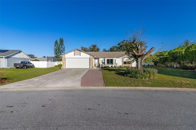 ranch-style house featuring a front yard and a garage