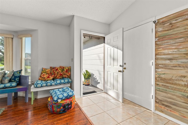 entrance foyer featuring a textured ceiling and light wood-type flooring