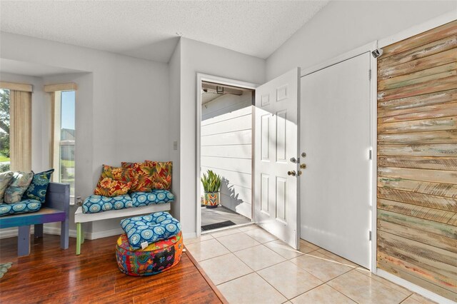 1402 Westminster Way, Kissimmee, FL 34744 - foyer entrance with light tile patterned floors, a textured ceiling, and baseboards
