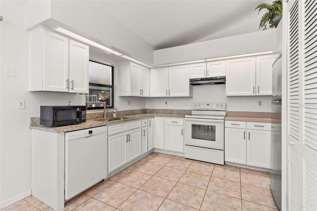 kitchen featuring white cabinets, a textured ceiling, light tile patterned floors, and white appliances