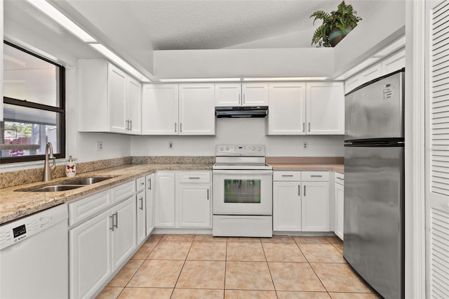 kitchen featuring sink, white cabinets, a textured ceiling, and white appliances