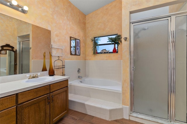 bathroom featuring vanity, wood-type flooring, and separate shower and tub