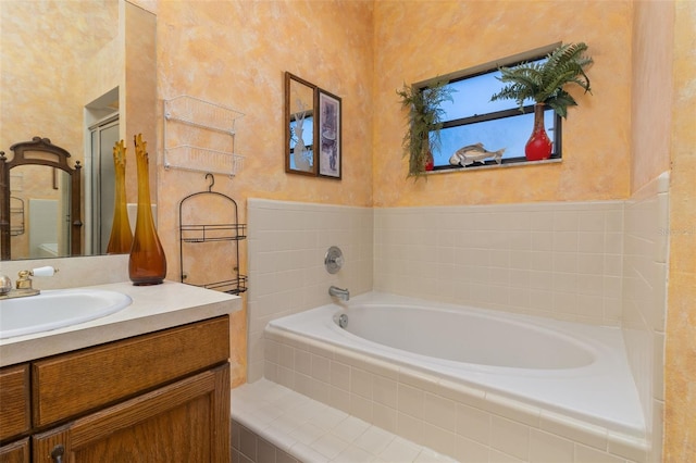 bathroom with vanity and independent shower and bath