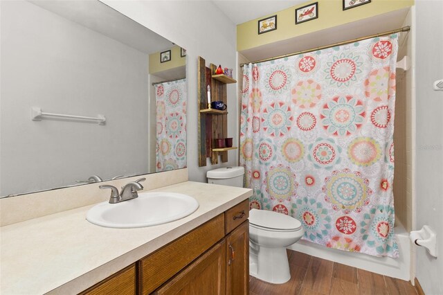 1402 Westminster Way, Kissimmee, FL 34744 - bathroom featuring vanity, toilet, wood finished floors, and shower / tub combo with curtain