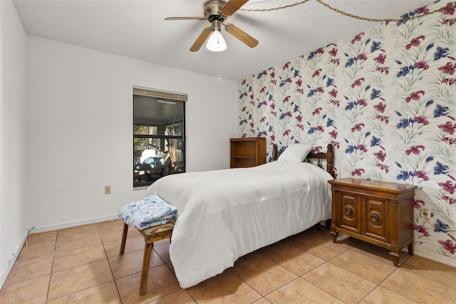 tiled bedroom featuring a textured ceiling and ceiling fan