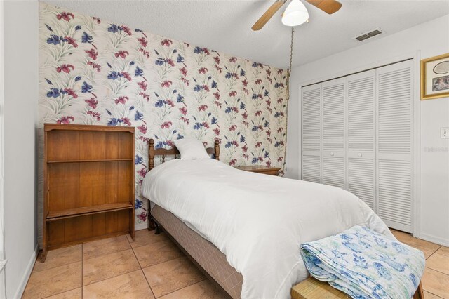 1402 Westminster Way, Kissimmee, FL 34744 - bedroom with a closet, tile patterned flooring, baseboards, and ceiling fan