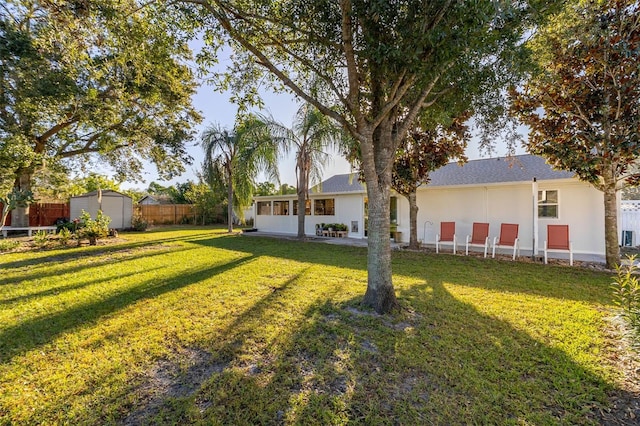 view of yard featuring a shed and a patio area