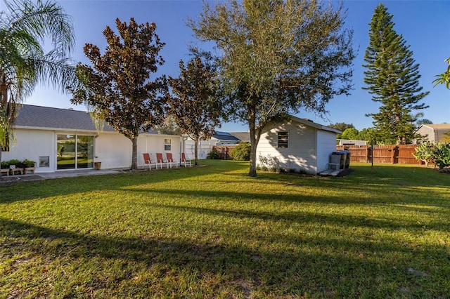 view of yard with an outbuilding and a patio