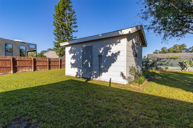 exterior space featuring a storage unit and a yard