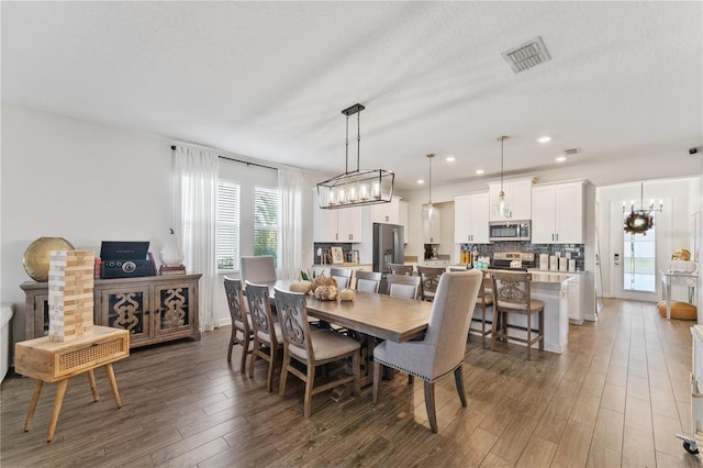 dining room featuring a textured ceiling and dark wood-type flooring