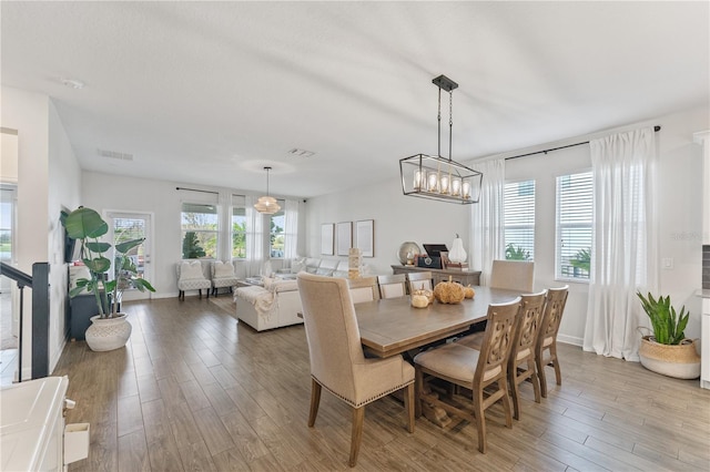 dining room featuring a notable chandelier and light wood-type flooring