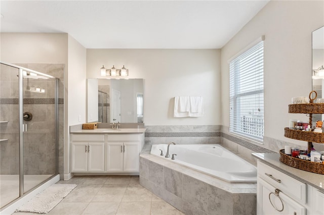 bathroom with vanity, tile patterned floors, and shower with separate bathtub