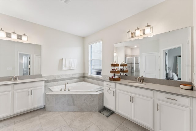 bathroom with vanity, tile patterned floors, and shower with separate bathtub