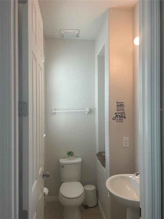 bathroom with tile patterned floors, toilet, and sink