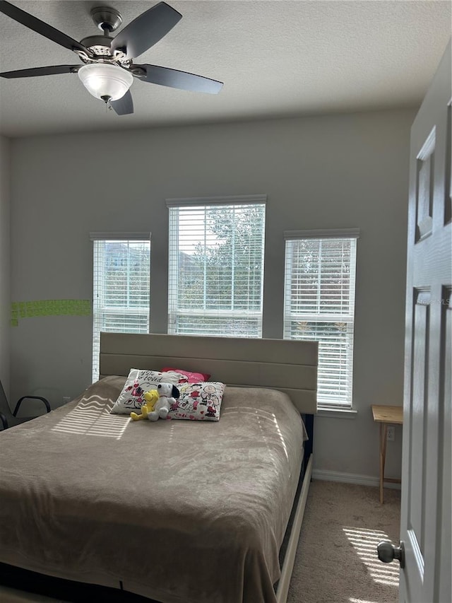 bedroom with ceiling fan and carpet flooring