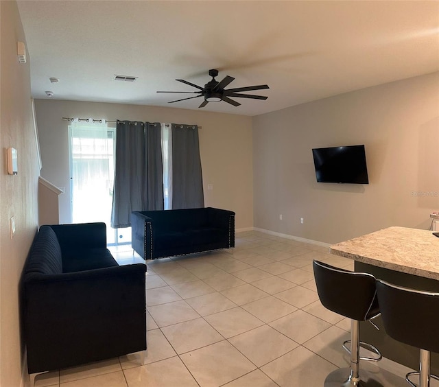 living room with light tile patterned floors and ceiling fan