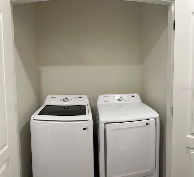 laundry area with independent washer and dryer