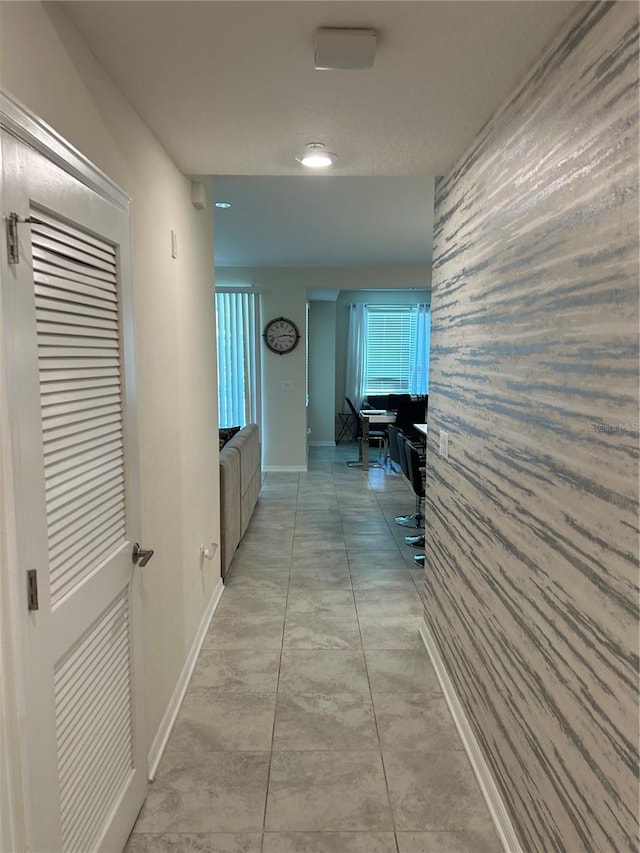 hallway featuring light tile patterned flooring